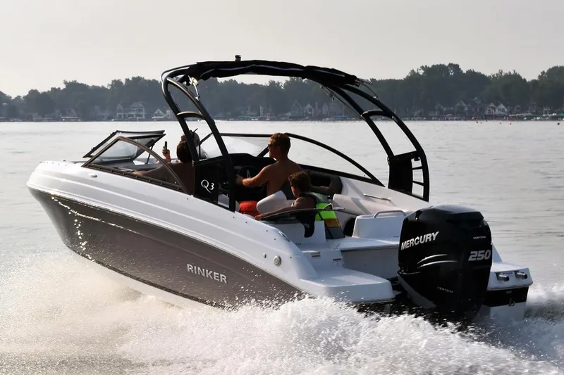 Slide: The Image of 2019 Rinker Q3 OB speedboat cruising on a lake with passengers. - 2