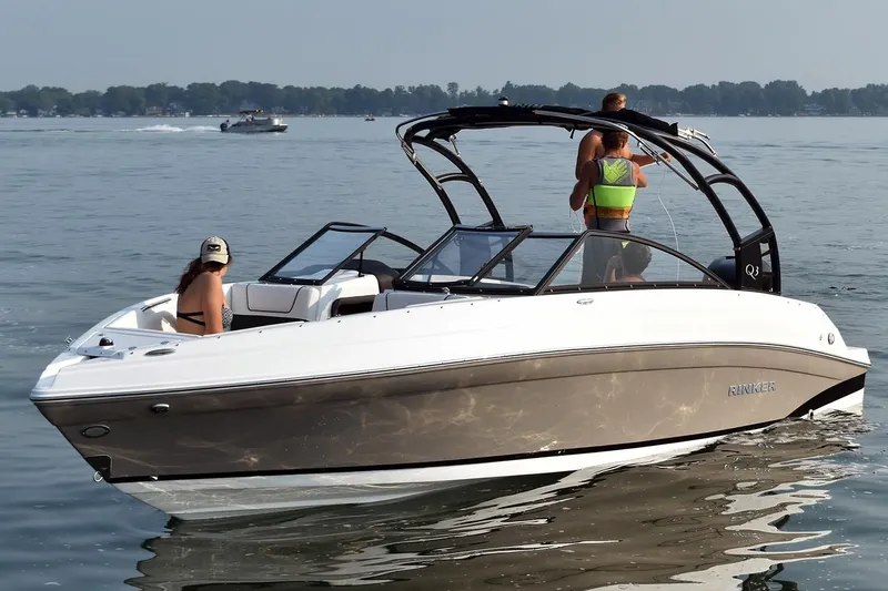 Slide: The Image of 2019 Rinker Q3 OB boat on a lake with two people onboard. - 3