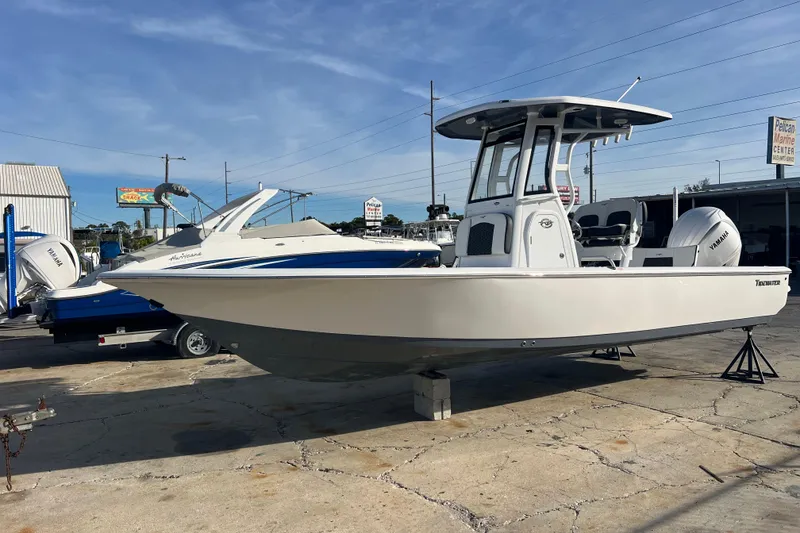 The Image of 2026 Tidewater 2410 Bay Max boat displayed at a marina with Yamaha engine. - 0