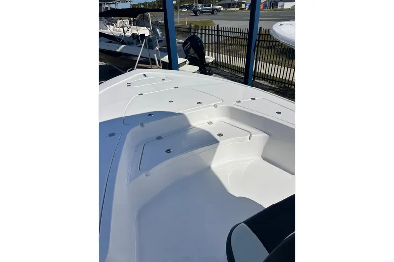 Slide: The Image of 2026 Tidewater 2410 Bay Max boat interior with storage compartments and seating. - 11