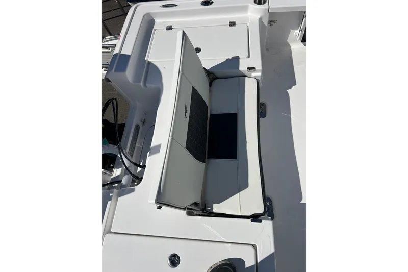Slide: The Image of 2026 Tidewater 2410 Bay Max boat interior with seating and storage compartment. - 14