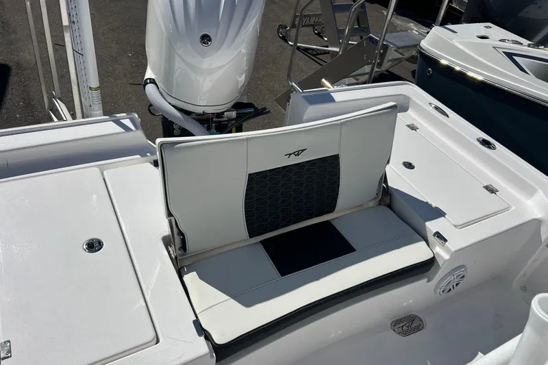 Slide: The Image of 2026 Tidewater 2410 Bay Max boat interior with seating and motor detail. - 15
