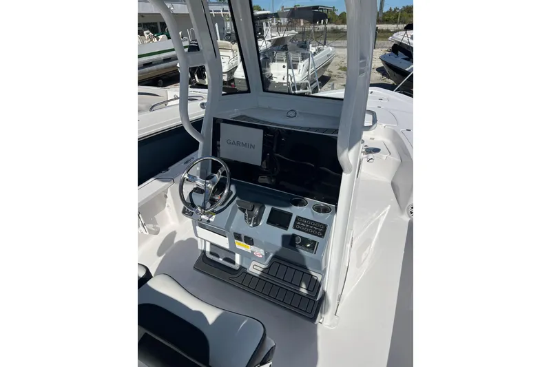 Slide: The Image of 2026 Tidewater 2410 Bay Max boat console with Garmin display and steering wheel. - 4