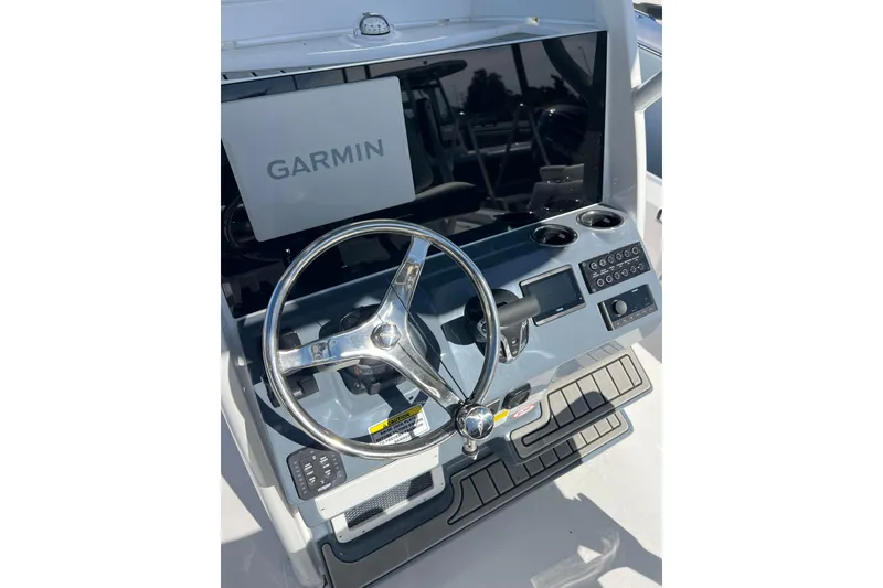Slide: The Image of 2026 Tidewater 2410 Bay Max boat console with Garmin display and steering wheel. - 8