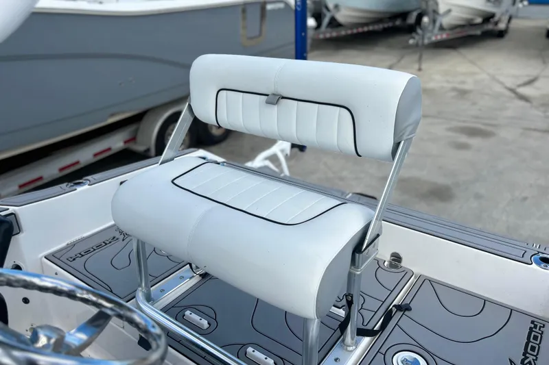 Slide: The Image of Yamaha Boats 2019 190 FSH Sport, white seating detail, docked with other boats. - 11