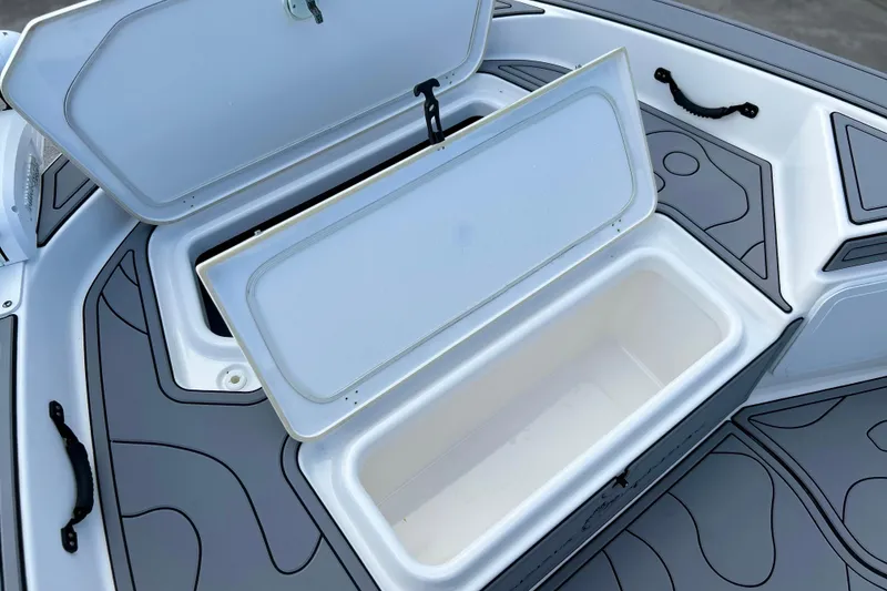 Slide: The Image of Open storage compartment on 2019 Yamaha Boats 190 FSH Sport, featuring sleek gray design. - 17