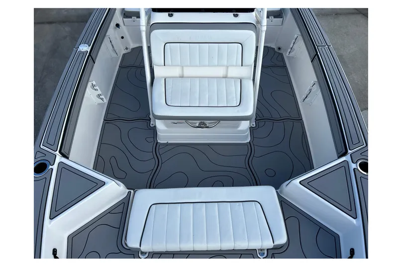 Slide: The Image of 2019 Yamaha Boats 190 FSH Sport interior with white seating and patterned flooring. - 20