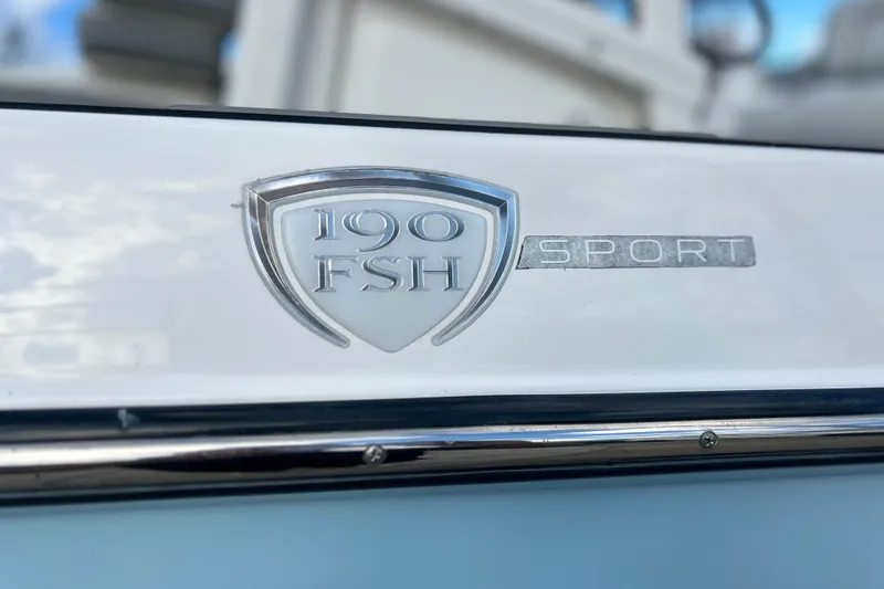 Slide: The Image of 2019 Yamaha Boats 190 FSH Sport emblem on boat exterior. - 4