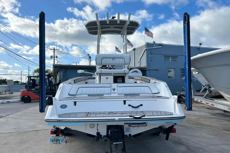 Slide: The Image of 2019 Yamaha Boats 190 FSH Sport docked, showcasing rear view and sleek design. - 6