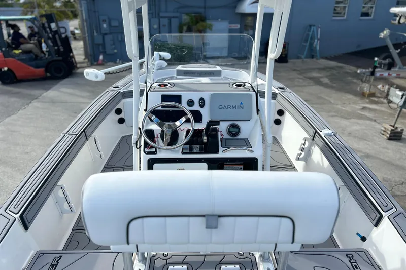 Slide: The Image of 2019 Yamaha Boats 190 FSH Sport interior with Garmin navigation system and steering wheel. - 8