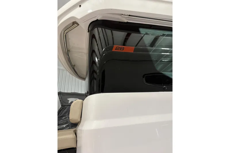 Slide: The Image of 2022 Axopar 28 CABIN boat, close-up of cabin window and exterior design. - 13