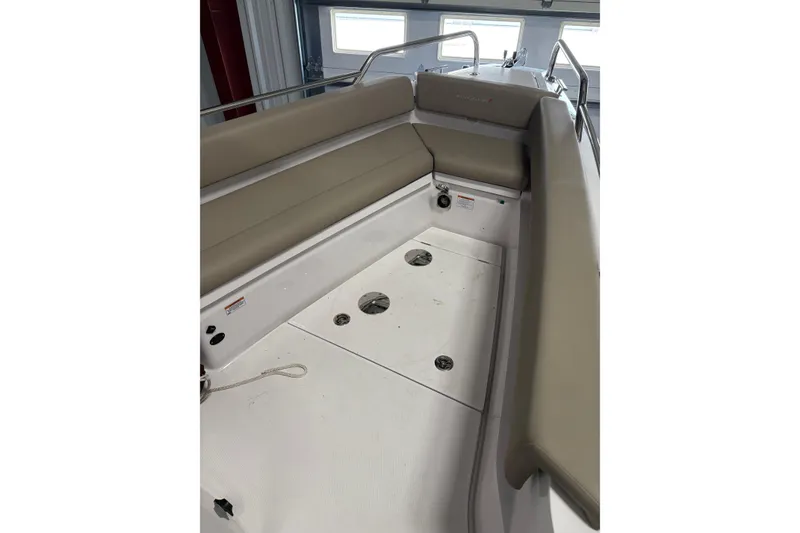 Slide: The Image of 2022 Axopar 28 CABIN interior with beige seating and white deck. - 15