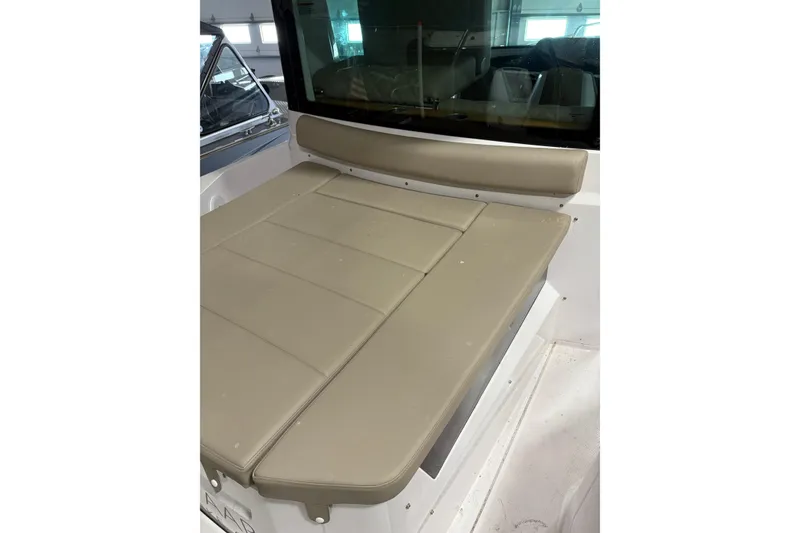 Slide: The Image of 2022 Axopar 28 CABIN interior seating area with beige cushions. - 18