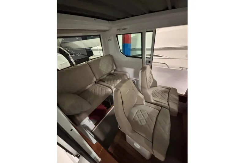 Slide: The Image of Interior of 2022 Axopar 28 CABIN with beige seating and modern design. - 20