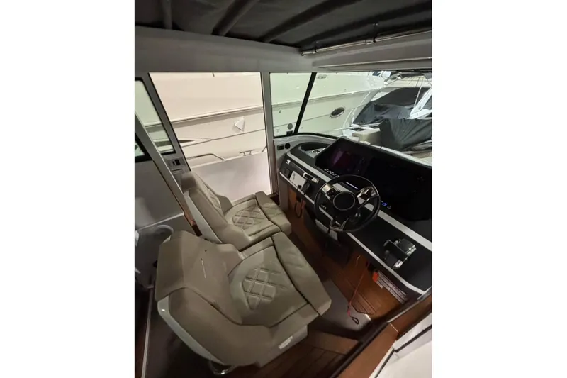 Slide: The Image of Interior of 2022 Axopar 28 CABIN boat with modern steering and seating. - 21