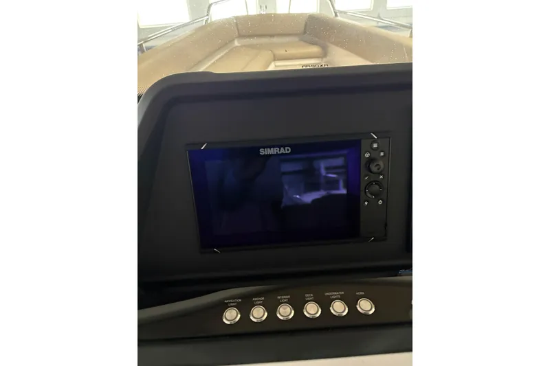 Slide: The Image of Simrad navigation system on 2022 Axopar 28 CABIN boat dashboard. - 29
