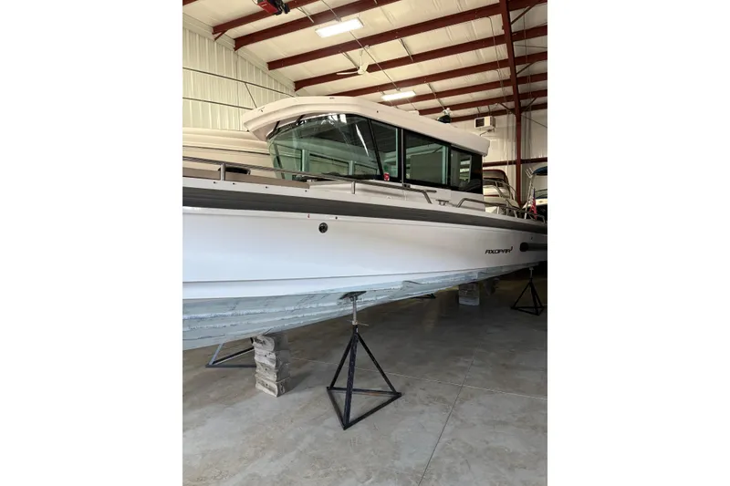 Slide: The Image of 2022 Axopar 28 CABIN boat in indoor storage, side view. - 3