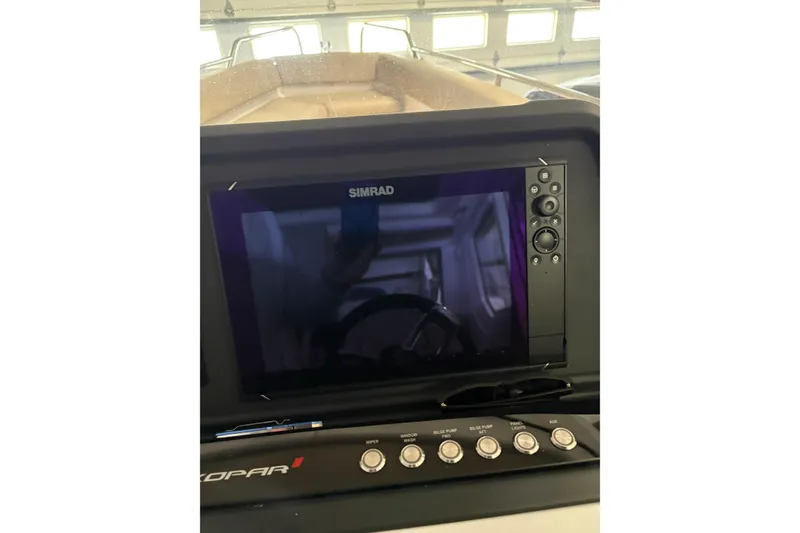 Slide: The Image of Simrad display on 2022 Axopar 28 CABIN boat dashboard with control buttons. - 32