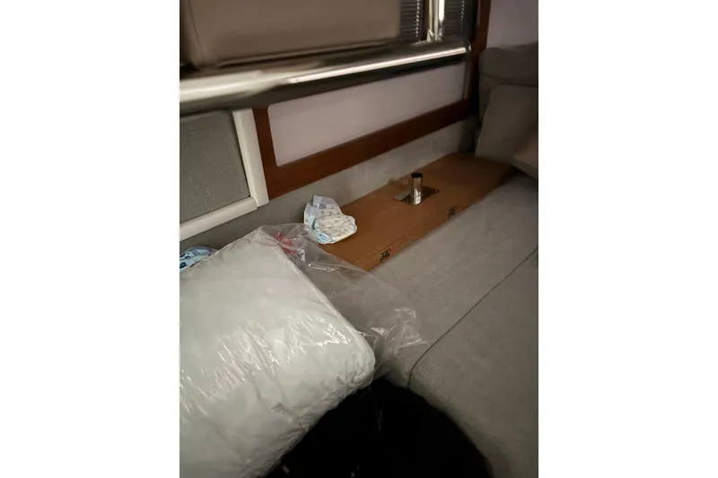 Slide: The Image of Interior of 2022 Axopar 28 CABIN with cushions and wooden table. - 35