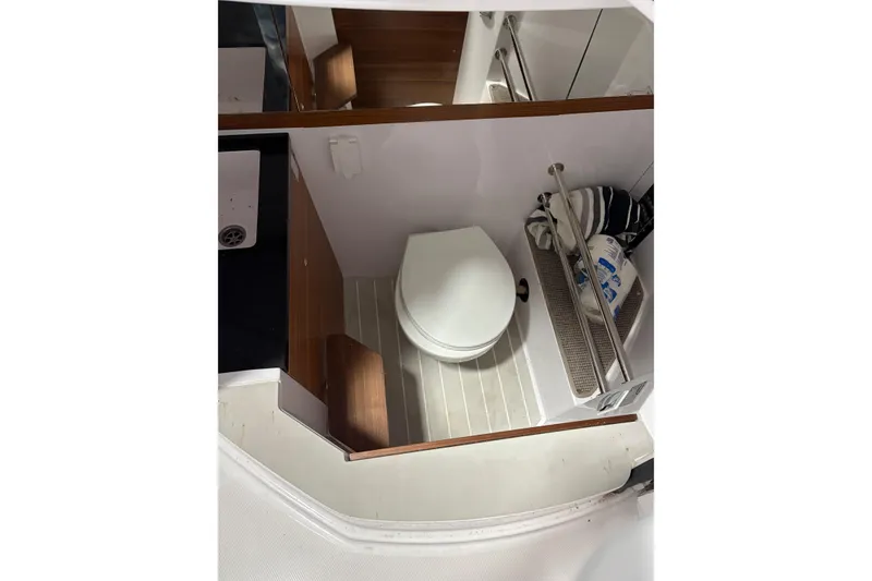 Slide: The Image of 2022 Axopar 28 CABIN interior bathroom with toilet and storage space. - 37