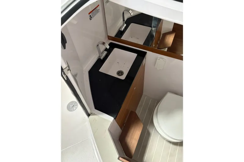 Slide: The Image of 2022 Axopar 28 CABIN bathroom with sink, mirror, and toilet. - 41