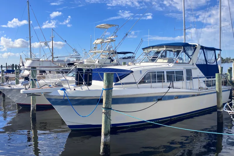 The Image of 1985 Chris-Craft 381 Catalina yacht docked at marina under blue sky. - 1