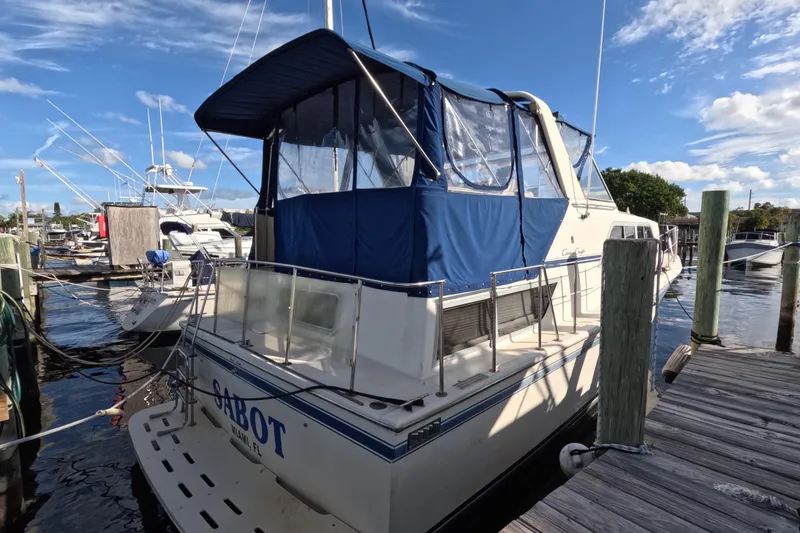 Slide: The Image of 1985 Chris-Craft 381 Catalina docked at marina under blue sky. - 11