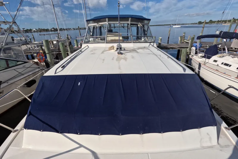 Slide: The Image of 1985 Chris-Craft 381 Catalina yacht docked at marina under blue sky. - 21