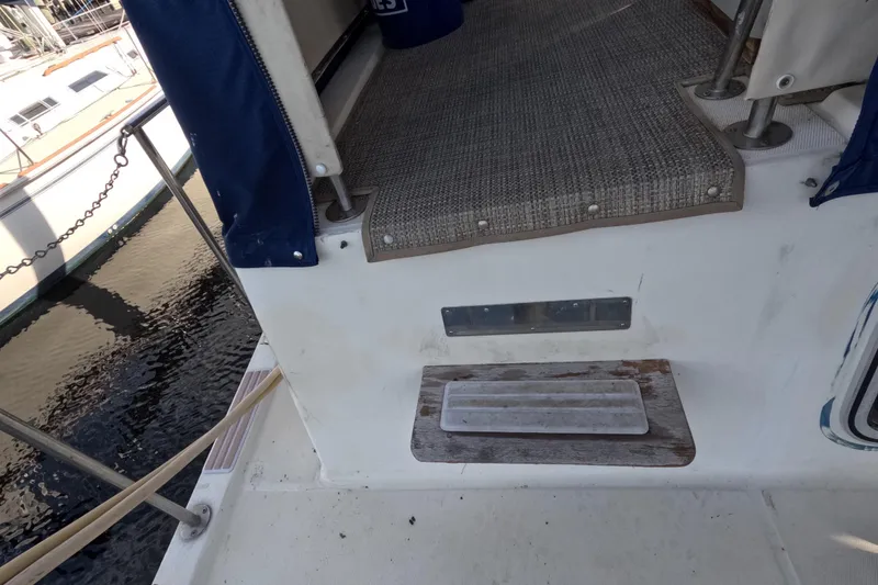 Slide: The Image of 1985 Chris-Craft 381 Catalina boat deck with steps and railing, docked by the water. - 28