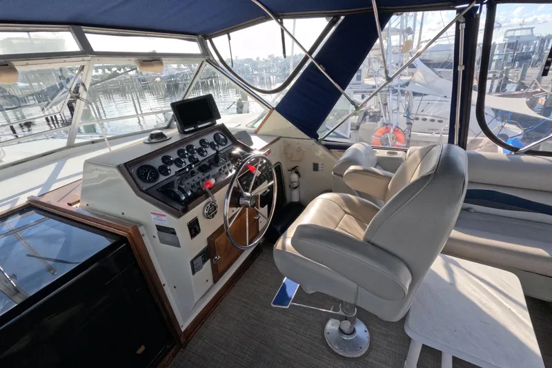Slide: The Image of 1985 Chris-Craft 381 Catalina helm with steering wheel, gauges, and captain's chair. - 31
