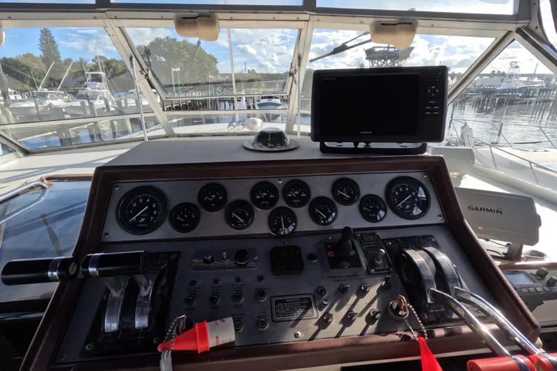Slide: The Image of 1985 Chris-Craft 381 Catalina helm with gauges and Garmin navigation system at marina. - 33