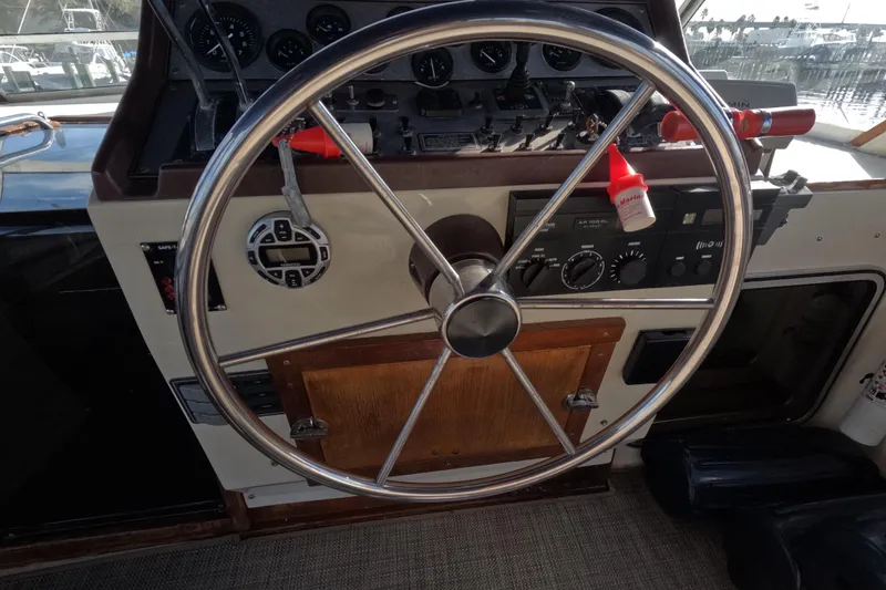 Slide: The Image of 1985 Chris-Craft 381 Catalina helm with steering wheel and control panel. - 34
