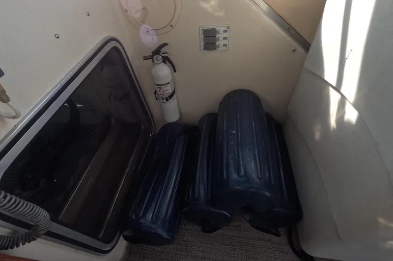 Slide: The Image of 1985 Chris-Craft 381 Catalina interior with fire extinguisher and boat fenders. - 35