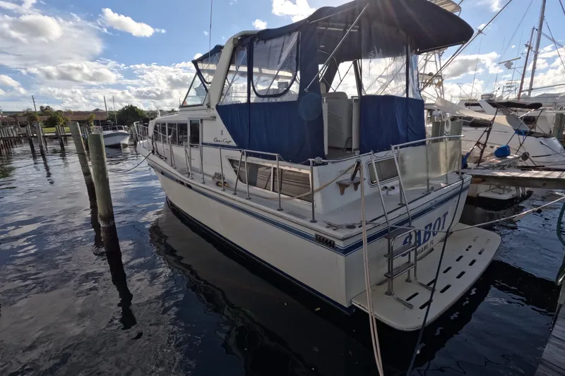 Slide: The Image of 1985 Chris-Craft 381 Catalina yacht docked at marina under blue sky. - 4