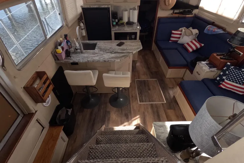 Slide: The Image of 1985 Chris-Craft 381 Catalina interior with kitchen, seating, and nautical decor. - 40