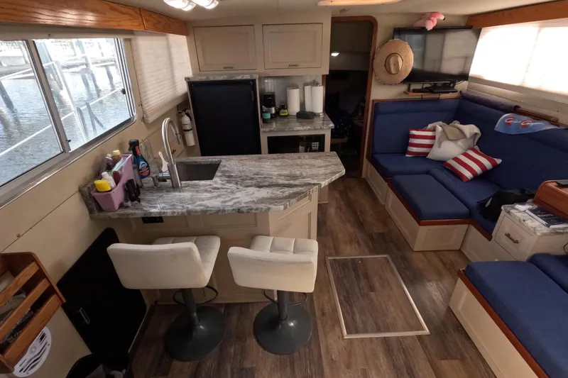 Slide: The Image of Interior of 1985 Chris-Craft 381 Catalina yacht with modern kitchen and cozy seating area. - 42