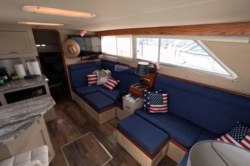 Slide: The Image of Interior of 1985 Chris-Craft 381 Catalina with blue seating and American flag pillows. - 43