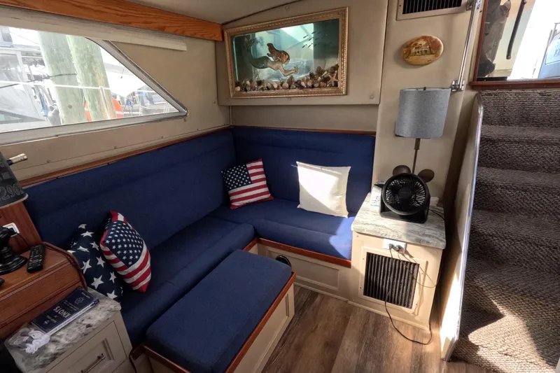 Slide: The Image of Cozy interior of 1985 Chris-Craft 381 Catalina with blue seating and nautical decor. - 44