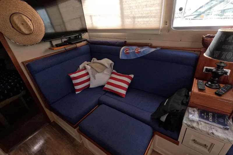 Slide: The Image of Interior of 1985 Chris-Craft 381 Catalina with blue seating, striped pillows, and nautical decor. - 45