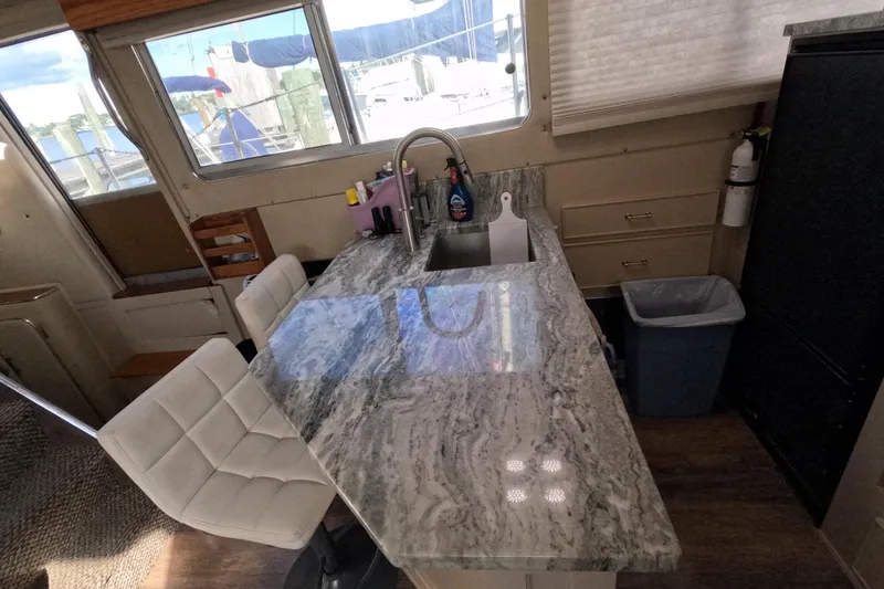 Slide: The Image of Interior of 1985 Chris-Craft 381 Catalina with marble countertop and modern kitchen amenities. - 48