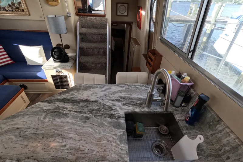 Slide: The Image of Interior of 1985 Chris-Craft 381 Catalina yacht with marble countertop and cozy seating area. - 49