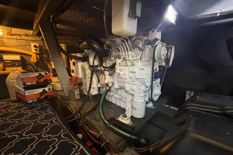 Slide: The Image of Engine room of 1985 Chris-Craft 381 Catalina with visible machinery and equipment. - 52