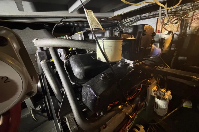 Slide: The Image of Engine room of 1985 Chris-Craft 381 Catalina, showcasing mechanical components and wiring. - 55