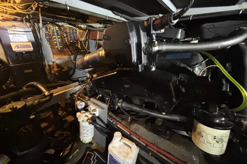 Slide: The Image of Engine room of 1985 Chris-Craft 381 Catalina, showcasing mechanical components and wiring. - 56