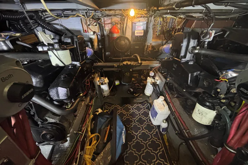 Slide: The Image of Engine room of a 1985 Chris-Craft 381 Catalina, featuring mechanical components and wiring. - 57