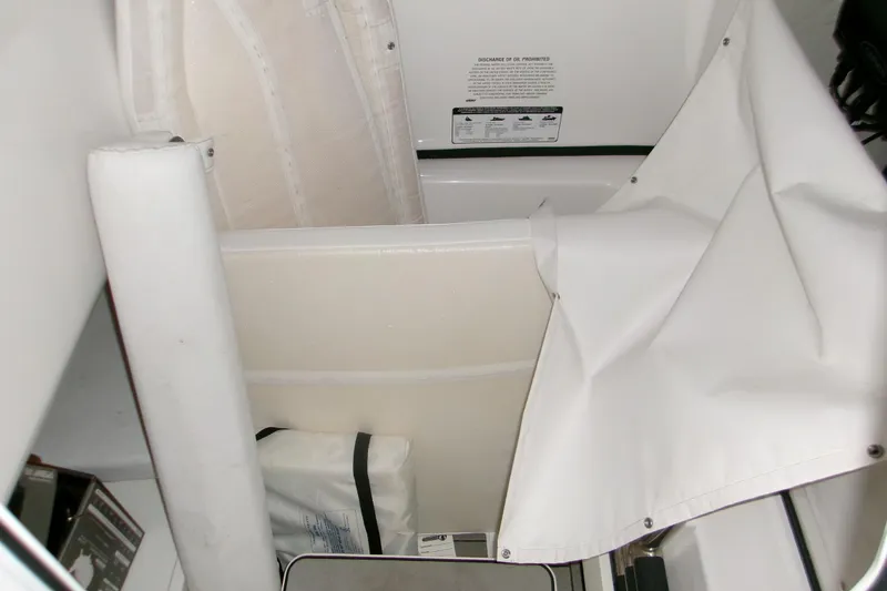 Slide: The Image of 2023 Sportsman Open 282 Center Console with Garmin equipment in a covered storage area. - 11