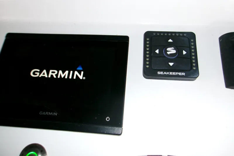 Slide: The Image of 2023 Sportsman Open 282 Center Console interior storage area with white fabric and equipment. - 12