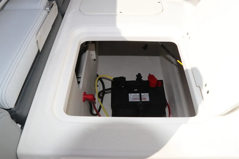 Slide: The Image of Battery compartment of 2026 Chaparral 21 SSi OB boat, featuring secure storage. - 14