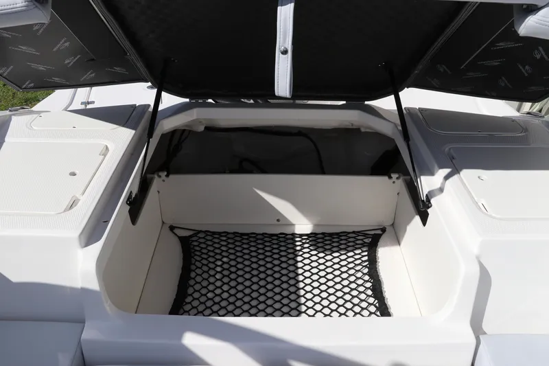 Slide: The Image of Open storage compartment on 2026 Chaparral 21 SSi OB boat with netting. - 15