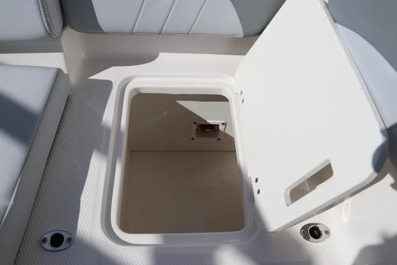 Slide: The Image of Open storage compartment on 2026 Chaparral 21 SSi OB boat interior. - 20